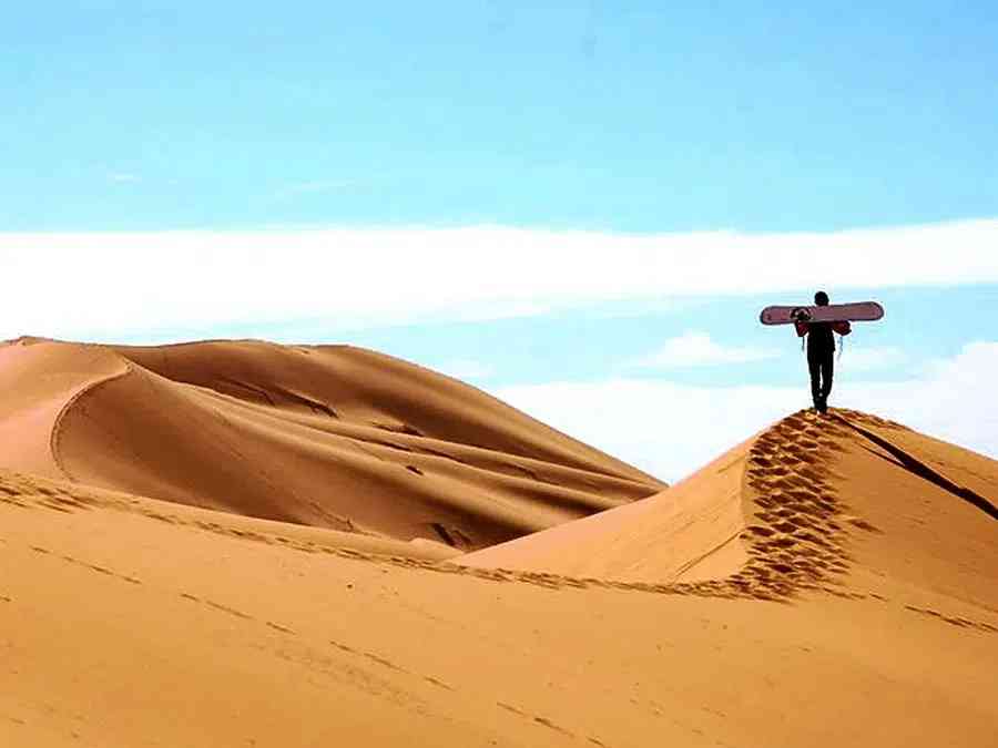 Sandboarding excitement awaits on the dunes during the 4-day Marrakech to Fes tour.