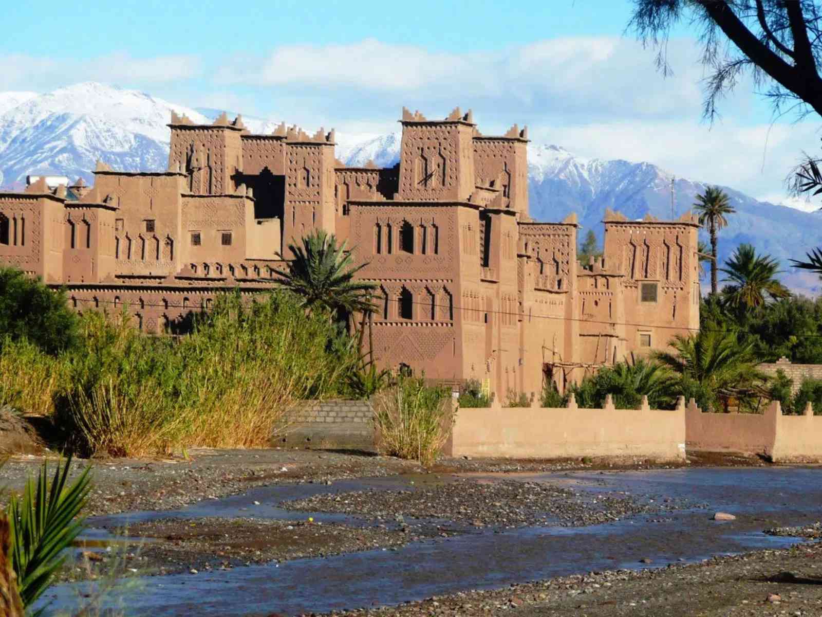 Visit the iconic Kasbah Amridil with the Atlas Mountains backdrop on your tour.